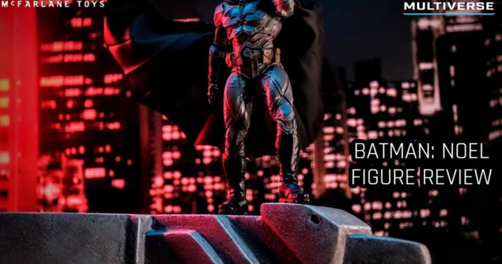 Batman: Noel action figure perched on a rooftop ledge, overlooking a detailed cityscape, showcasing dynamic posing and McFarlane Toys' intricate sculpt and design