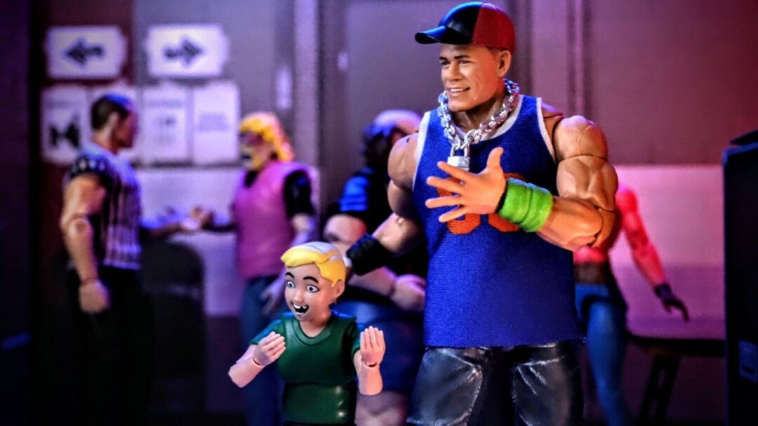 WWE Ultimate Fan TakeOver 2025 John Cena High-Five Moment Mattel WWE Ultimate Fan TakeOver 2025 John Cena WrestleMania 20 figure high-fiving young fan with background crowd.