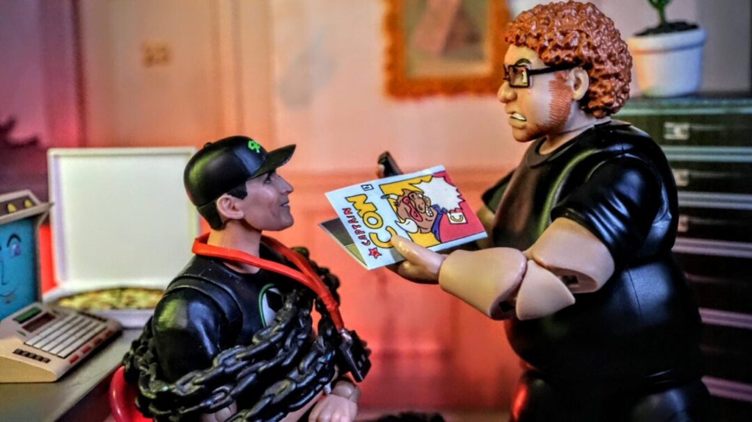 Todd McFarlane meets Figures Toy Company Lloyd Ultimate Wrestling Crowd Fan Figure in toy photography diorama scene for WWE, AEW, McFarlane Toys, and collectors.