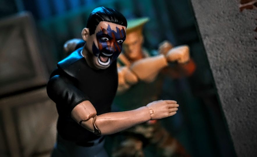 Figures Toy Company Ultimate Wrestling Fan Lance dodges a punch from Jada Toys Street Fighter 2 Guile in dramatic crossover scene