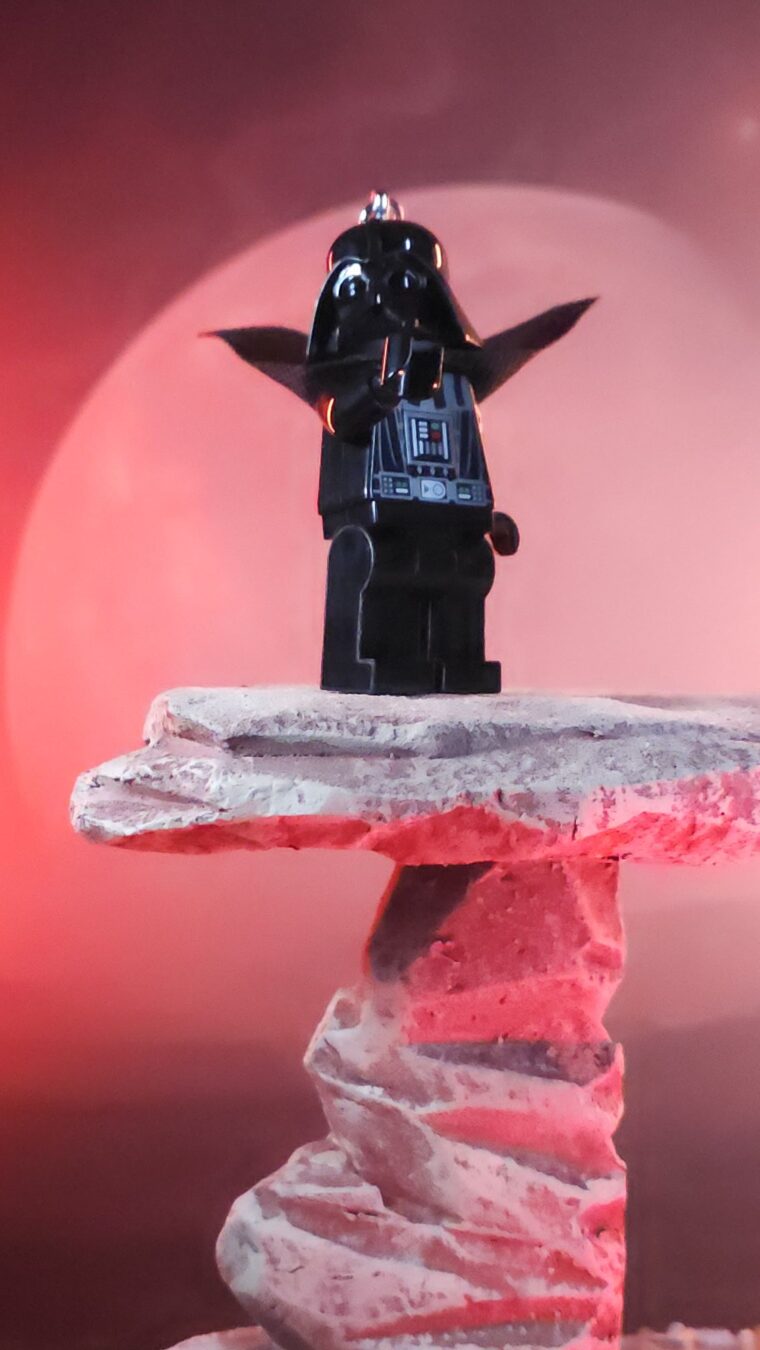 Santoki LEGO Darth Vader Keychain Light standing heroically on rock ledge in red moonlight