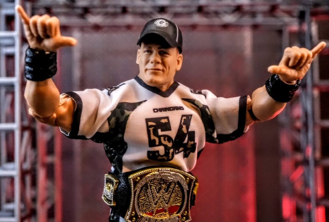 WWE Hall of Champions John Cena Elite Figure with WWE Championship Title Close-up of Mattel WWE Hall of Champions John Cena Elite figure with WWE Championship and “54” jersey on custom entrance stage