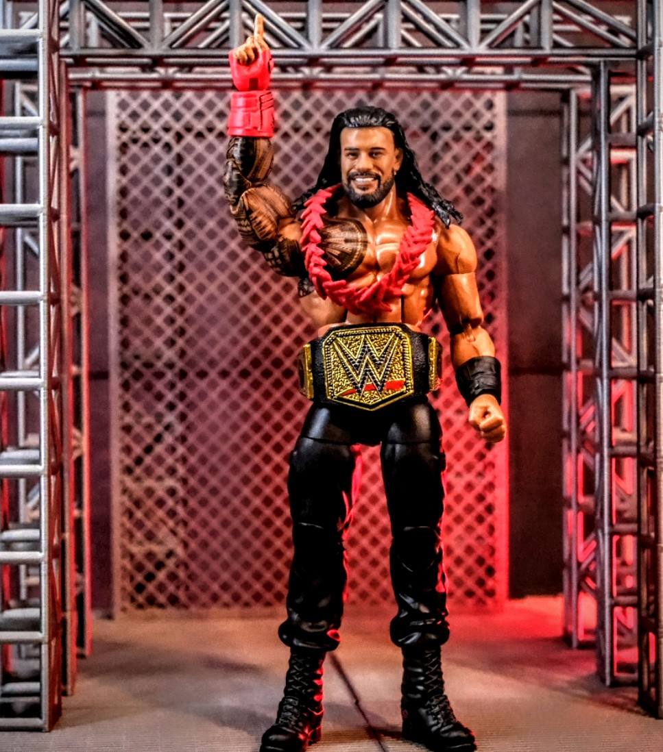 WWE Hall of Champions Roman Reigns Elite Figure with Universal Championship Title Mattel WWE Hall of Champions Roman Reigns Elite figure raising his arm with Universal Championship on custom entrance stage