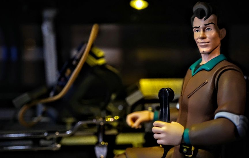 Eaglemoss Ecto-1 with Peter Venkman Figure Peter Venkman action figure with Eaglemoss Ecto-1 model, holding ghostbusting gear.