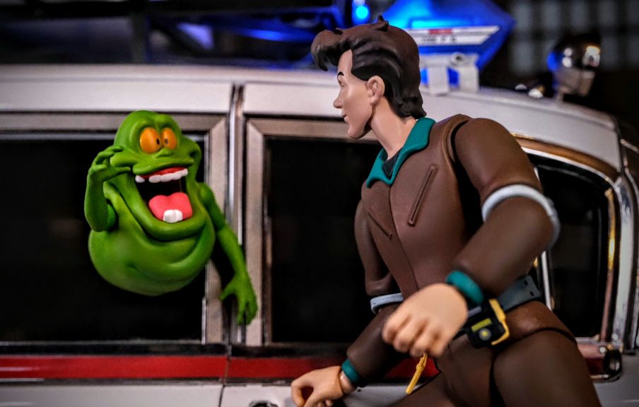 Peter Venkman and Slimer with Eaglemoss Ecto-1 Model Peter Venkman action figure with Slimer beside the Eaglemoss Ecto-1 model, highlighting scale and display options