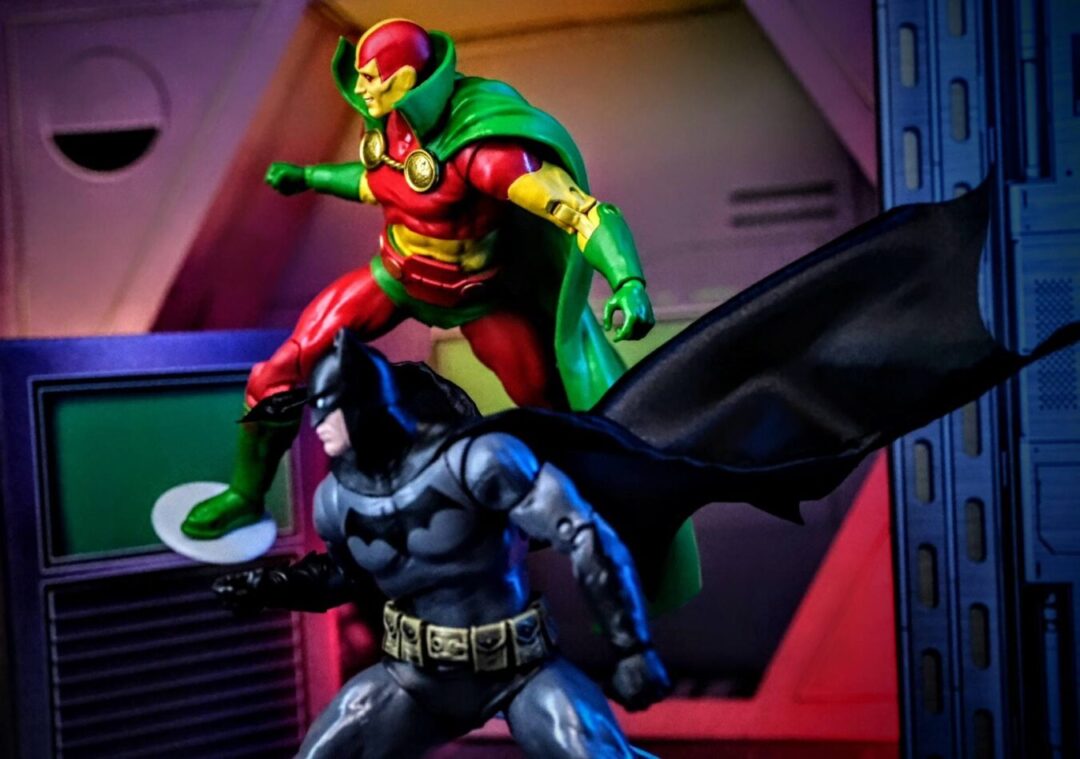 McFarlane Toys Mister Miracle and Batman Year One Gold Label Display McFarlane Toys DC Multiverse Mister Miracle Gold Label action figure posed above McFarlane Toys Batman Year One Gold Label figure