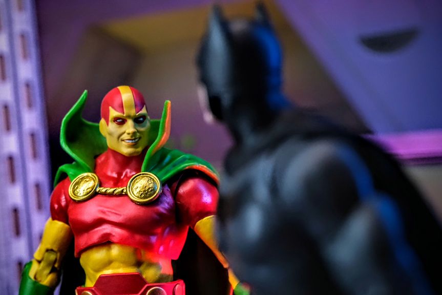 McFarlane Toys Mister Miracle Gold Label Close-Up with Batman Year One Close-up of McFarlane Toys DC Multiverse Mister Miracle Gold Label action figure with McFarlane Toys Batman Year One Gold Label figure blurred in background