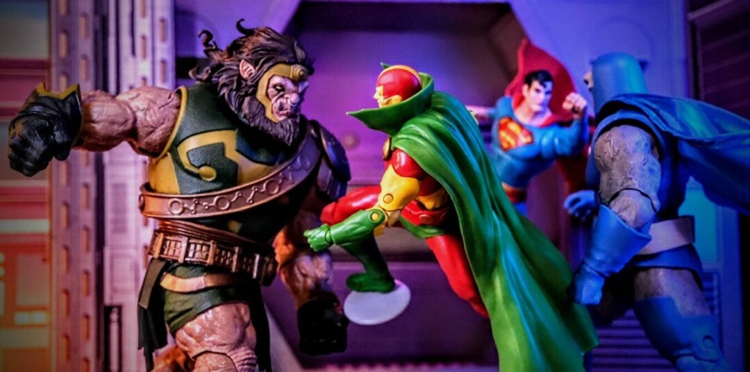 McFarlane Toys Mister Miracle Gold Label vs. Kalibak, Darkseid, and Superman Silver Age McFarlane Toys DC Multiverse Mister Miracle Gold Label action figure in battle with Kalibak, Darkseid Megafig, and Superman Silver Age digital collectible