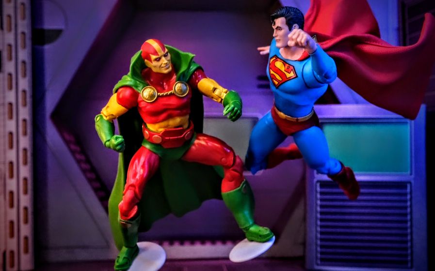 McFarlane Toys Mister Miracle Gold Label vs. Superman Silver Age Digital Collectible McFarlane Toys DC Multiverse Mister Miracle Gold Label action figure posed in battle with Superman Silver Age McFarlane Toys digital collectible
