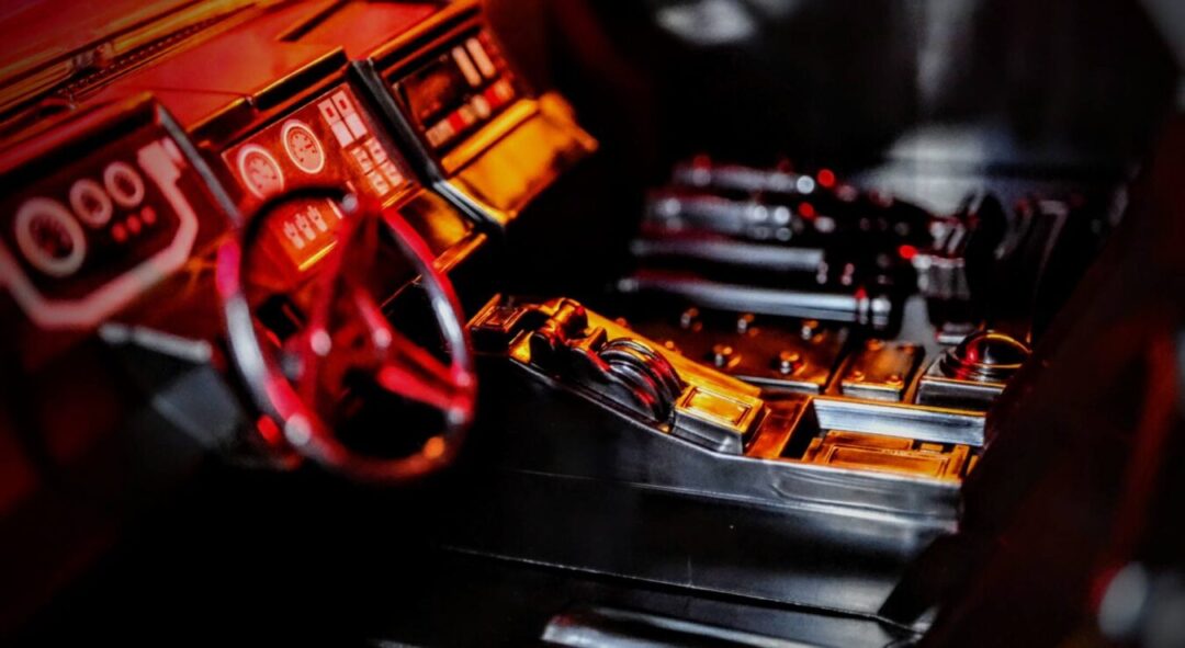 Detailed interior of McFarlane Toys The Batman Batmobile Gold Label showing dashboard and steering wheel