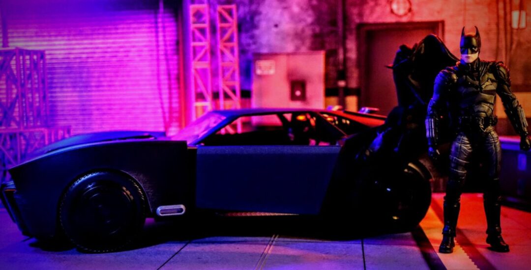 McFarlane Toys The Batman Batmobile Gold Label with Batman action figure posed beside the vehicle.