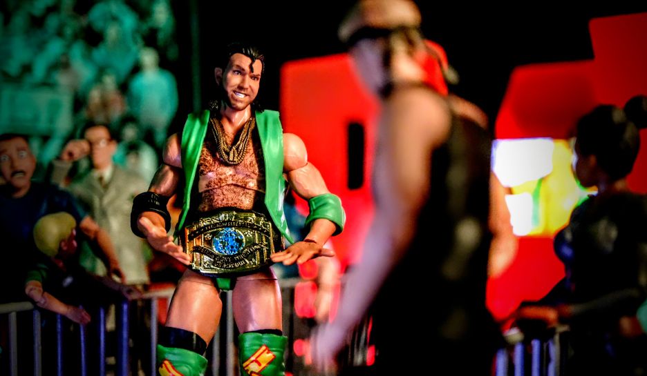 Mattel WWE Ultimates Razor Ramon figure holding Intercontinental Championship in green attire toy photography