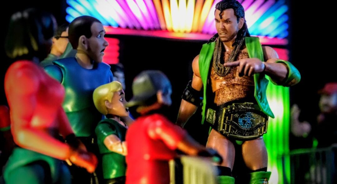 WWE Ultimates Razor Ramon Mattel action figure with championship belt interacting with crowd in toy photography setup