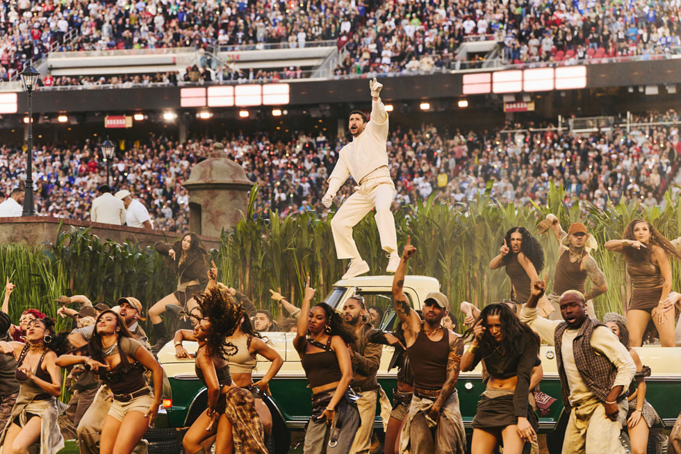Bad Bunny performing atop a car during the Apple Music Super Bowl LX Halftime Show