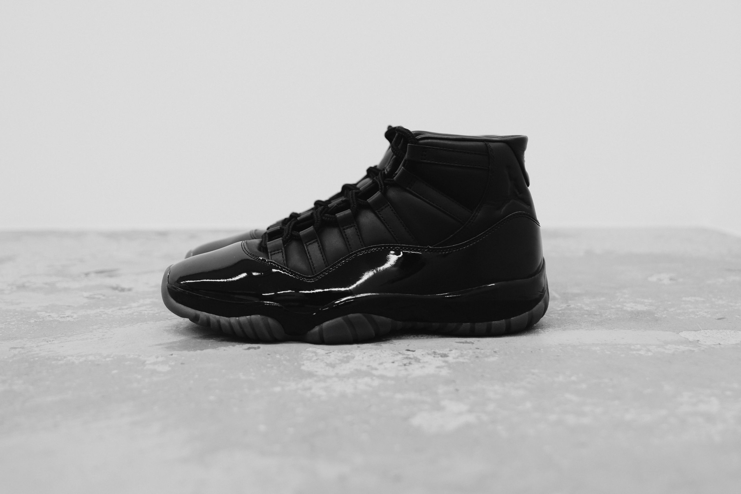 Comme des Garçons Homme Plus x Air Jordan 11 collaboration in black and white