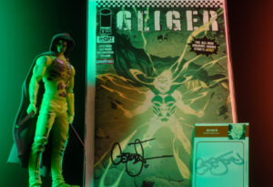 McFarlane Toys Geiger figure displayed beside Geiger number one and collectible autograph card